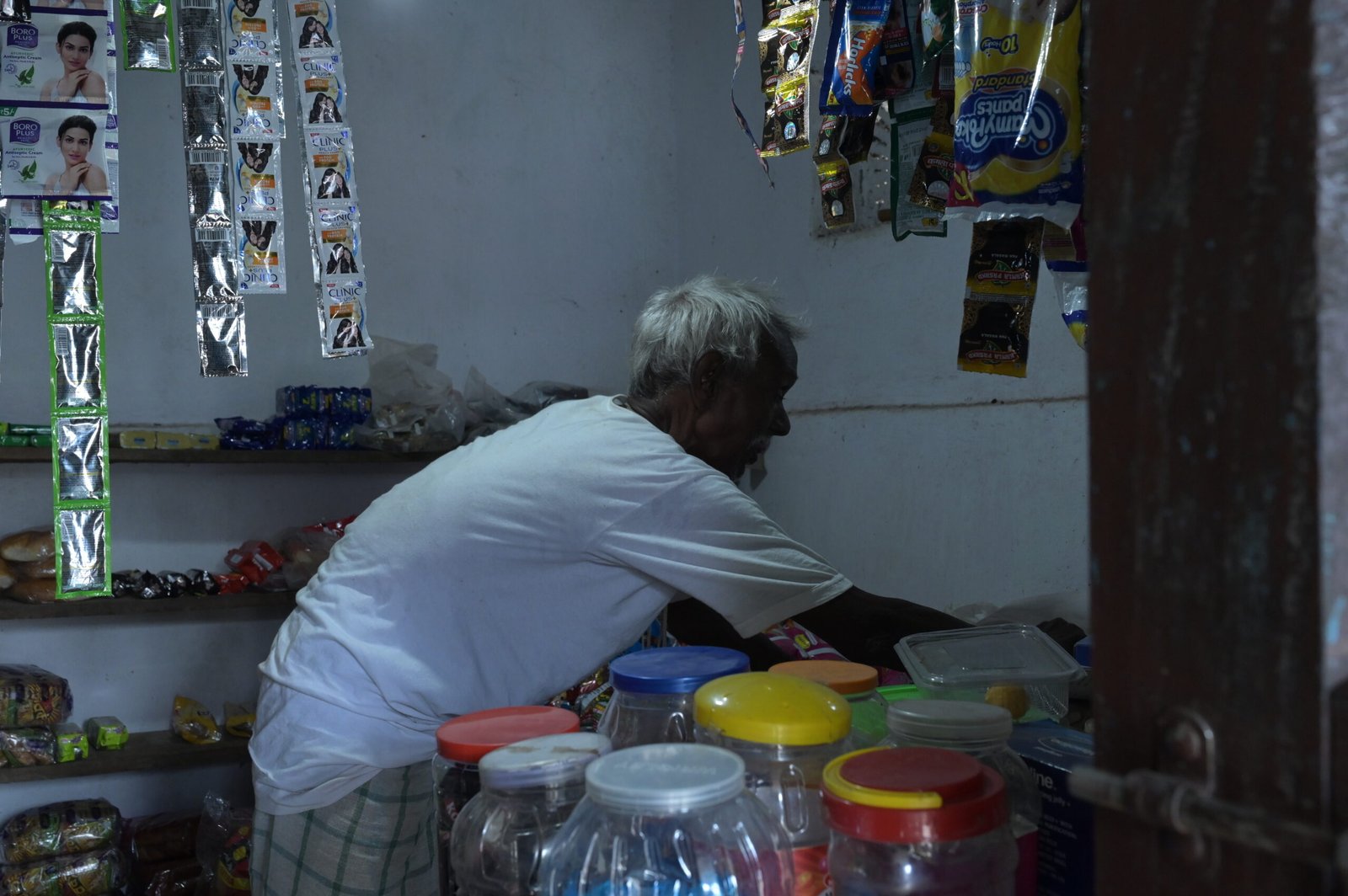 Sukhram Munda looking for documents inside his shop.
